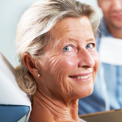 Older woman smiling from dental chair