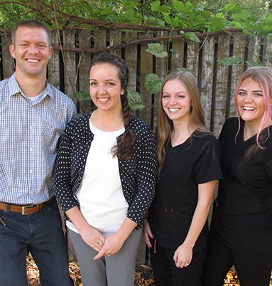 Dentist and staff group photo at Midtown Dental in Logan, Utah