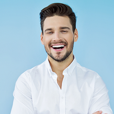 Young man in a white shirt smiling wide