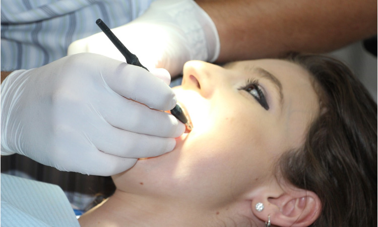 girl getting her teeth cleaned under dental sedation