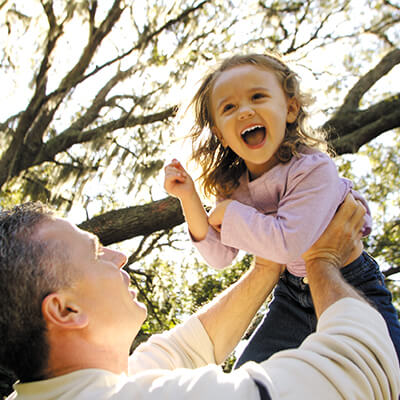 Dad plays with his daughter outside