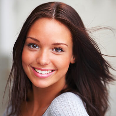 Brunette woman smiling with white teeth