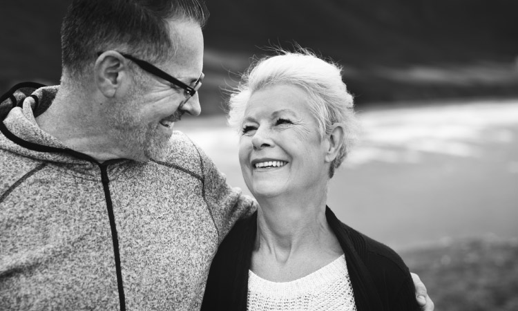 elderly couple gazing and smiling at each other