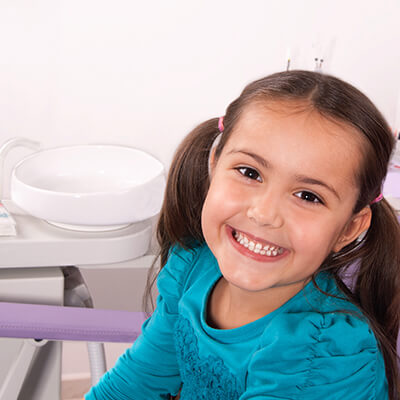 Young girl smiling wide during her dental visit