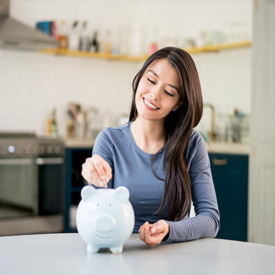 woman saving money in piggy bank
