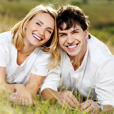 a young couple laying in a field