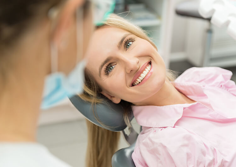 smiling woman sitting in a dental chair