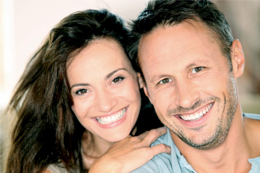 couple smile showing off their clear aligner teeth straightening