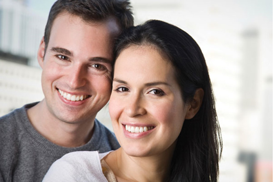 couple smile showing off their professional teeth whitening results