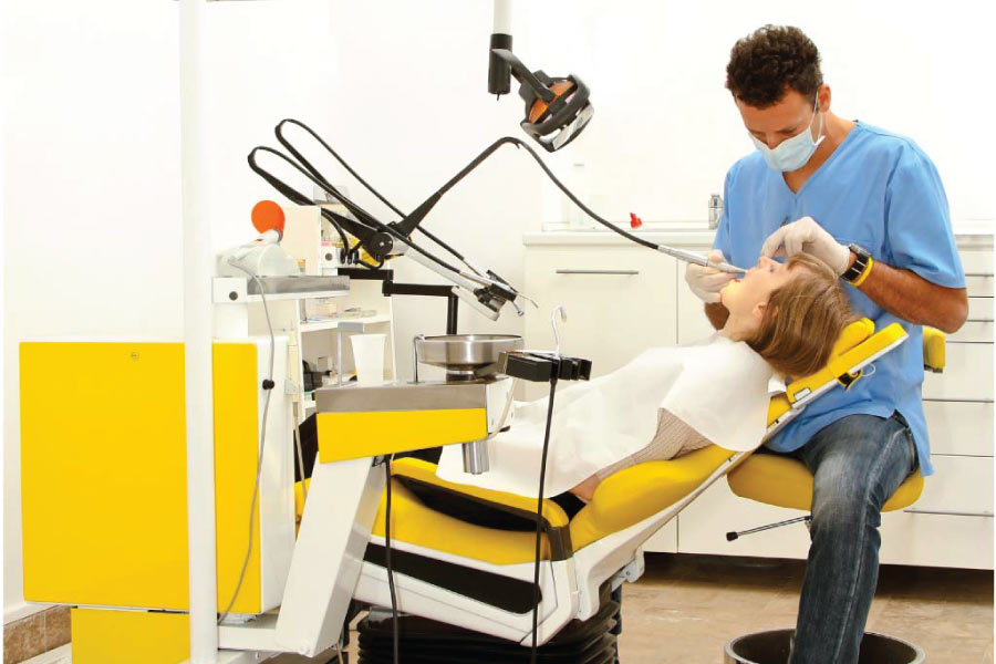 female patient getting a dental exam by the dentist