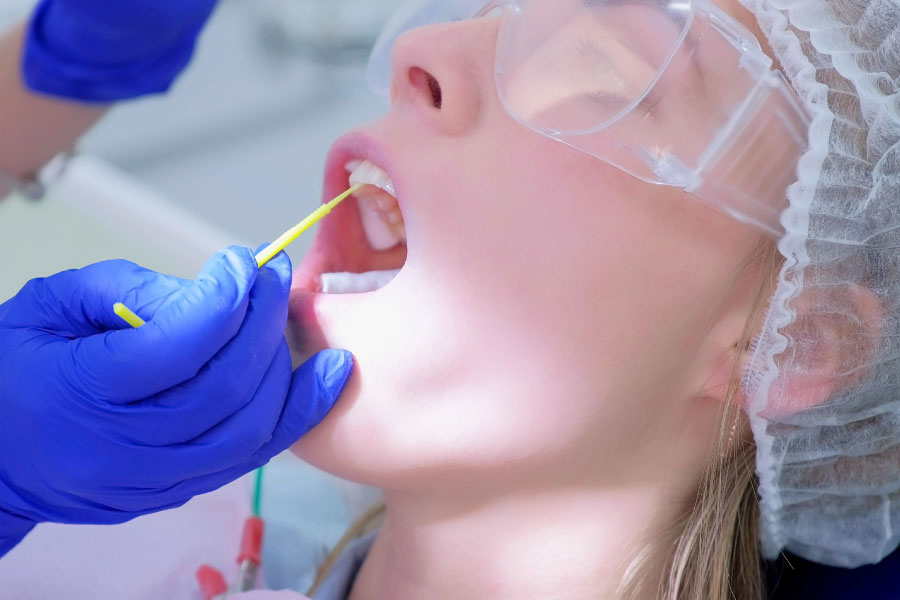Dental patient undergoing fluoride treatment.